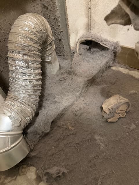 Dryer vent before cleaning with visible buildup from the new set
