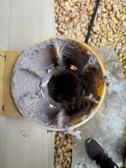Dryer vent before cleaning with lint buildup from the final dryer vent set