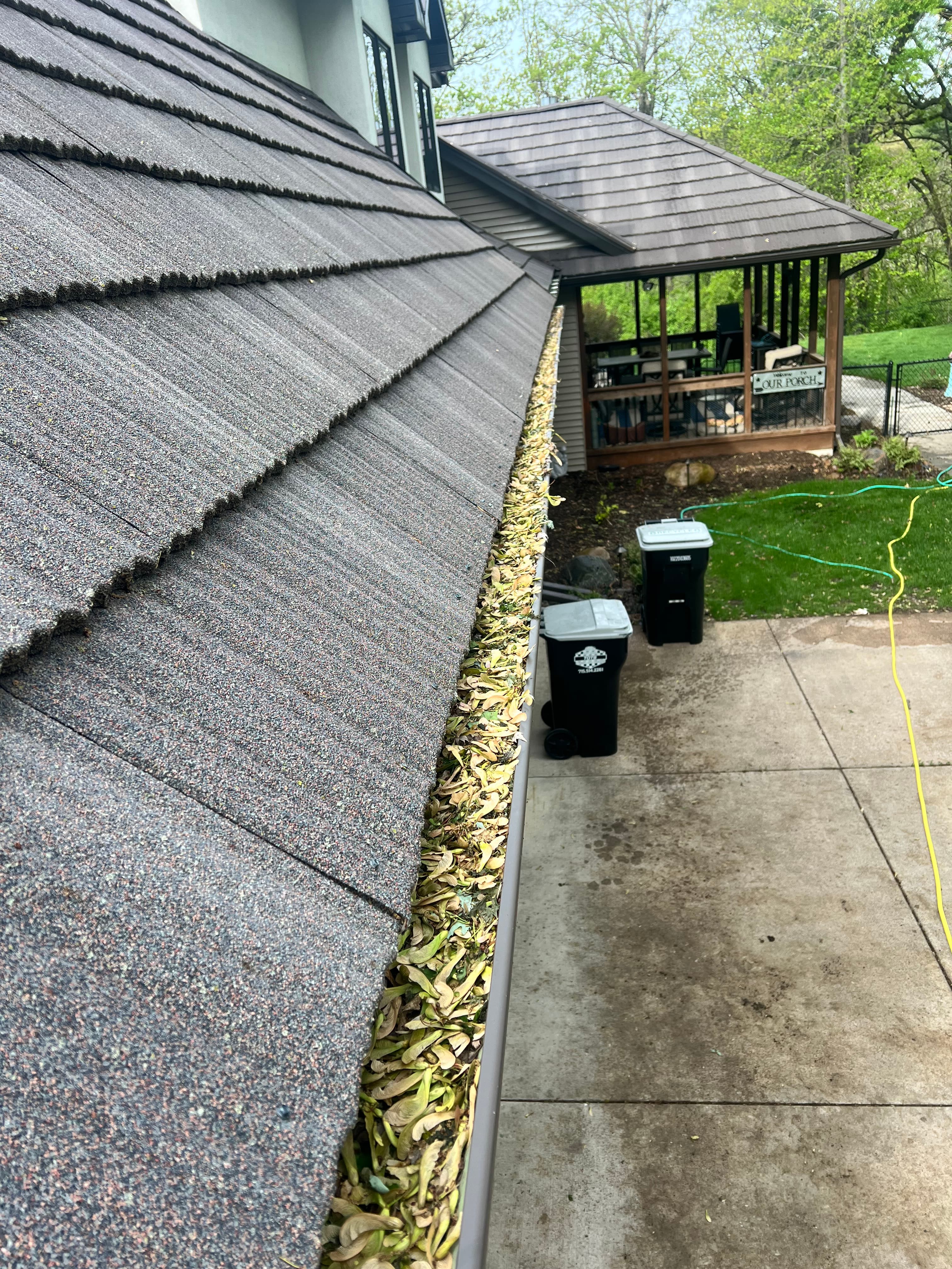 Gutter before cleaning with packed debris
