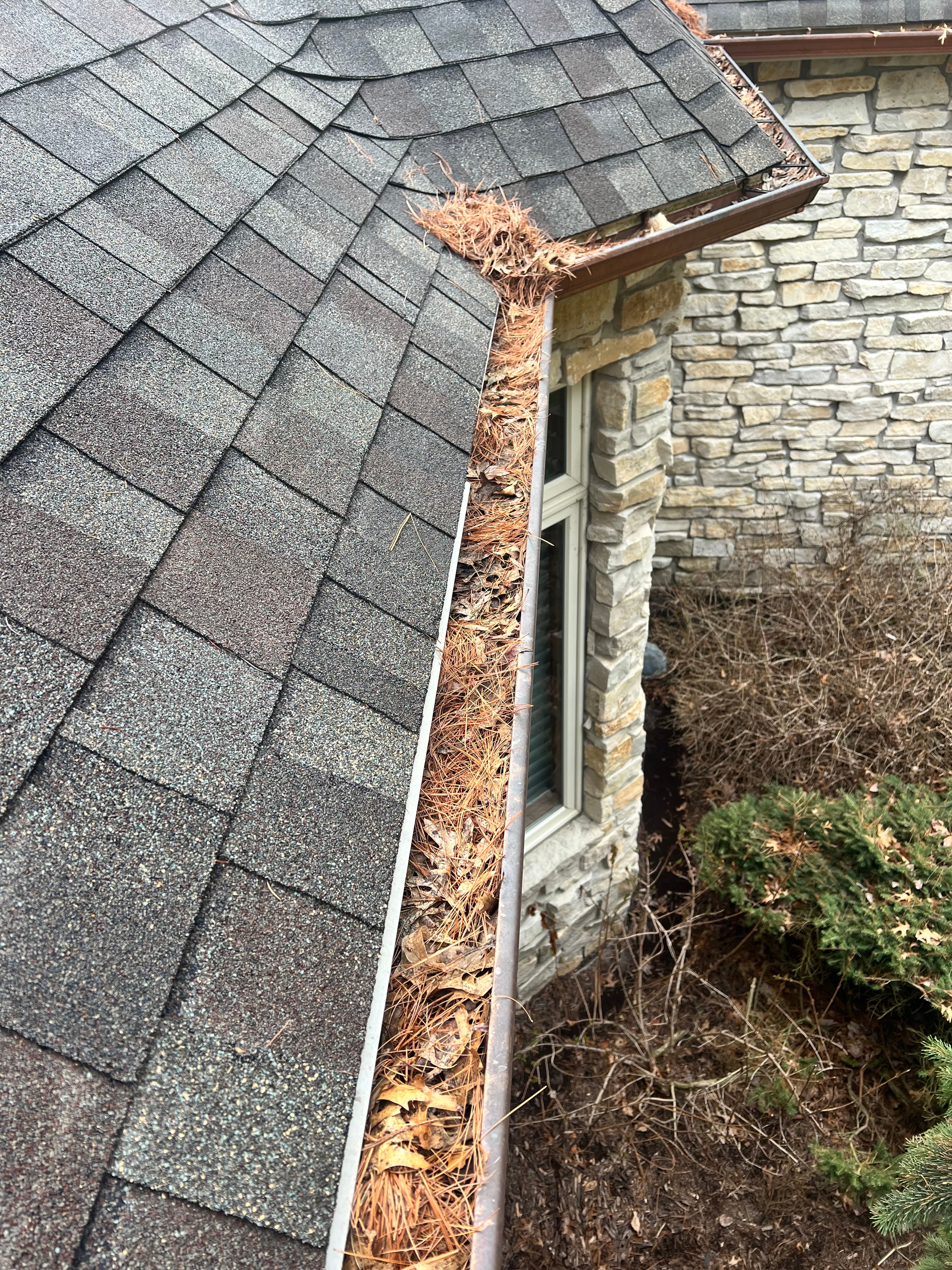 Gutter before cleaning with buildup and debris
