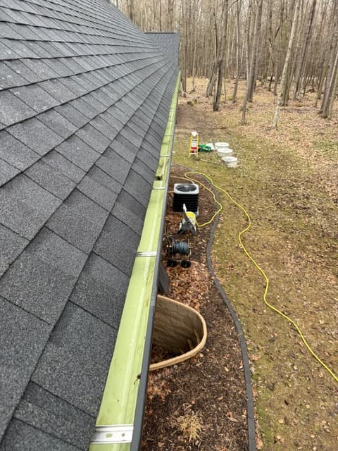 Gutter after cleaning with debris removed from the new gutter set