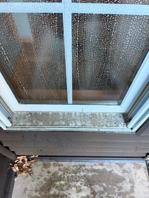 Window before professional cleaning with visible residue from the new set