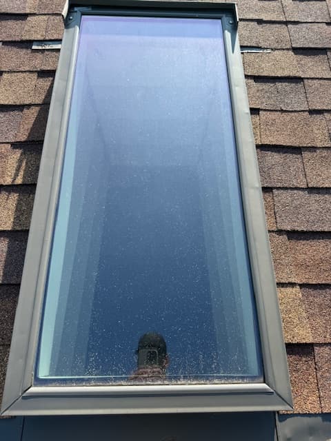 Window before professional cleaning with buildup on the pane