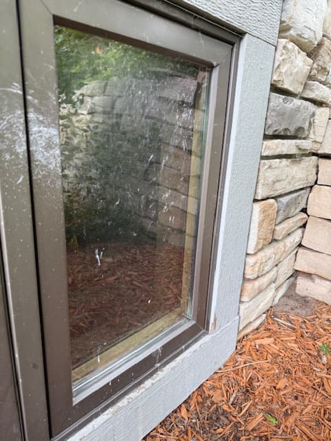 Window before professional cleaning with residue and buildup
